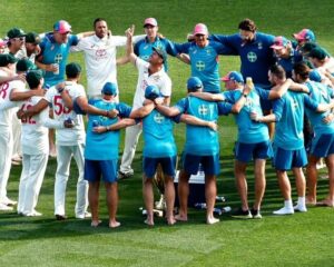 Warner in the middle of the team huddle